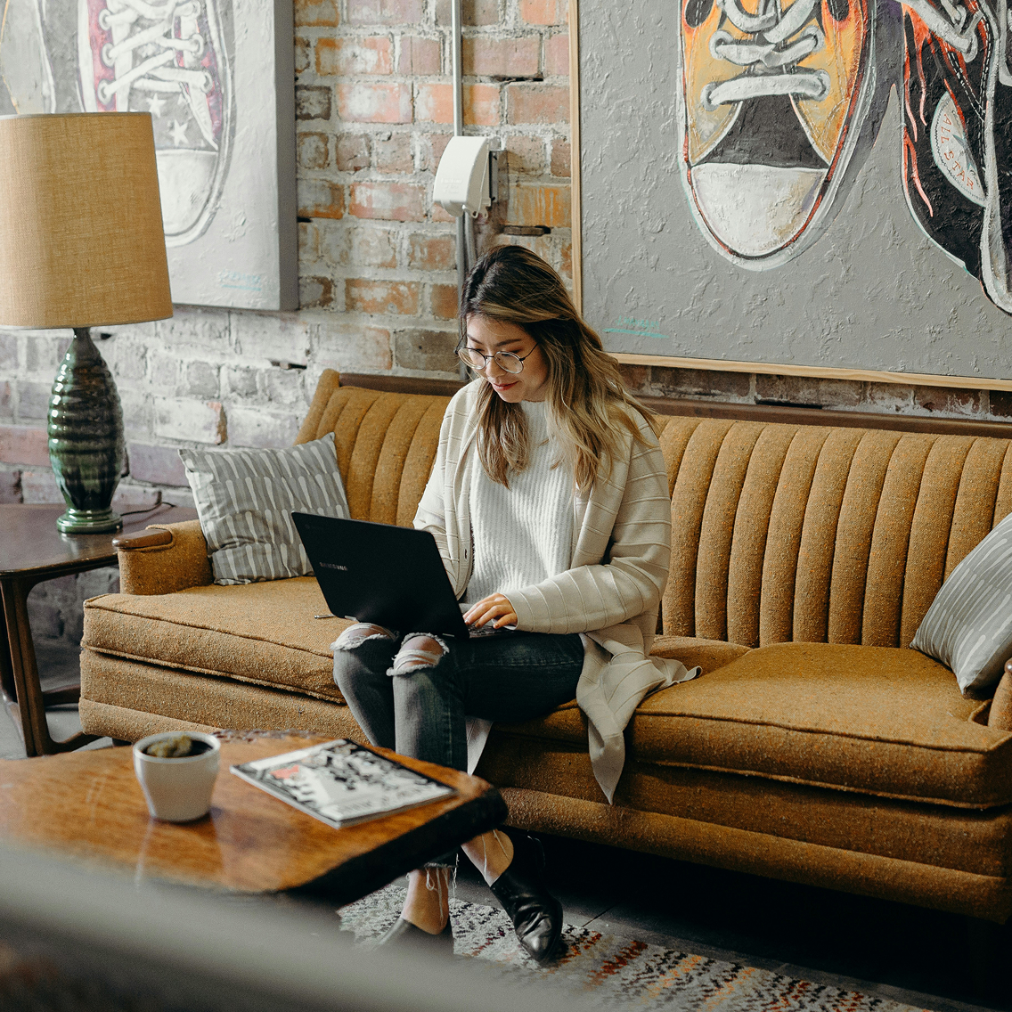 Person with laptop sitting on the couch